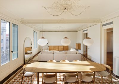 Comedor elegante con lámparas colgantes esféricas y mesa de madera